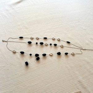 Black stones and silver necklace. Pair earrings are included.